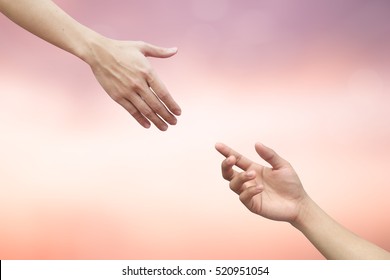 close up helping and blessing pray hands try to give and take on blur beautiful sunrise sky background for support to healing life and social distance concept.