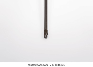 Close up high angle view of front of cross screw driver against white background. Photo taken December 25th, 2023, Zurich, Switzerland.