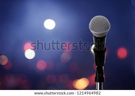 Close up of high fidelity microphone setting on stand with colorful light bokeh background in conference hall .
Microphone on stage .