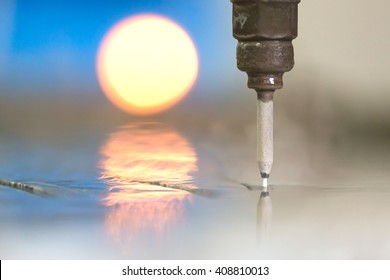 Close Up High Pressure Water Jet Stream Exits The Nozzle As A Three Phase Mixture Of Air, Water And Abrasive Particles During Granite Or Marble Tiles CNC Cutting In Factory Workshop