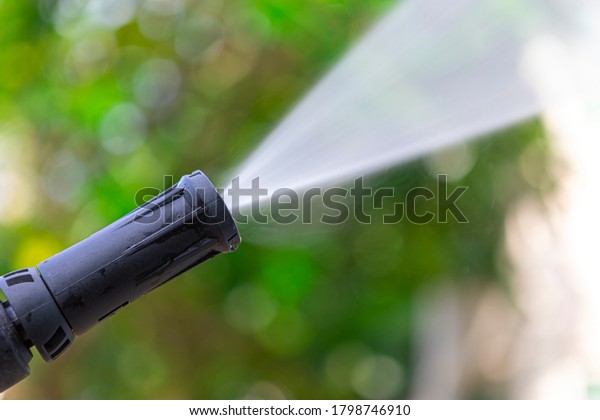 Close up of high pressure water nozzle on\
green nature background