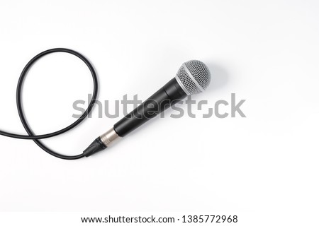 Close up of high quality dynamic microphone connect with male xlr connector and  cable isolated on white background,top view.
High fidelity microphone on white background with clipping path .
