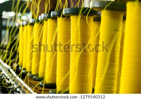 Image, Stock Photo Factory worker handling threads in a yarn production setup