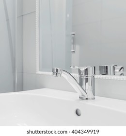 Close up of high quality white washbasin with simple tap