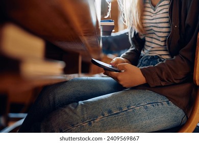 Close up of high school student texting on mobile phone during a lecture in the classroom. - Powered by Shutterstock