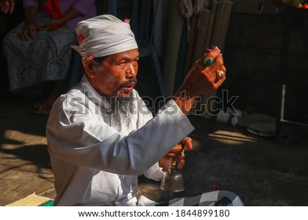Close up of Hindu priest prays during a wedding ceremony. The pedanda performs wedding ceremonies.