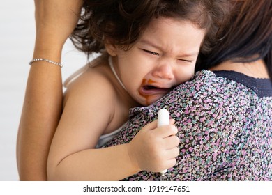 Close Up Hispanic Children Cry When Displeased. The Parents Comfort The Crying Baby.