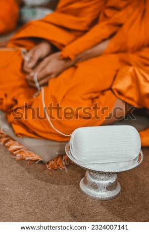 close up holy thread on tray, buddhist holy day, thai buddhist monk ordination ceremony wallpaper background concept