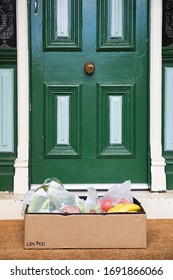 Close Up Of A Home Delivery Box Of Fresh Produce  Sitting On A Doormat During Home Isolation 