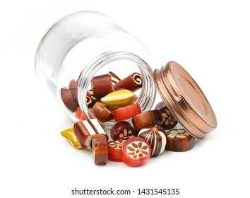 Close Up Homemade Hard Sugar Candy,boiled Sweet Spilt From Glass Jar And Lid Isolated On White Background