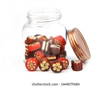 Close Up Homemade Hard Sugar Candy,boiled Sweet In Glass Jar And Lid Isolated On White Background