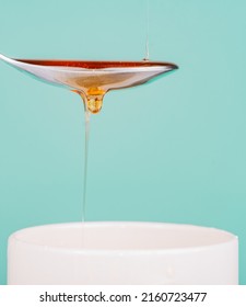Close Up Of Honey Being Poured Into A Silver Spoon, Honey Is A Natural Sweetener As A Substitute For Sugar
