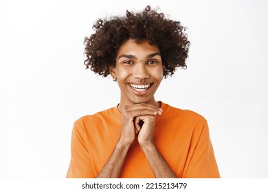 Close Up Of Hopeful Guy, Looking With Hope And Desire, Waiting For Something, Smiling, Standing Over White Background