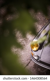 Close up horizontal image of the headlight of a vintage sport classic car.