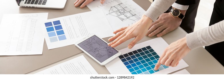 Close up horizontal photo of colleagues interior designers working with color swatches palette and blueprint, planning discussing together creative occupation concept banner for website header design - Powered by Shutterstock