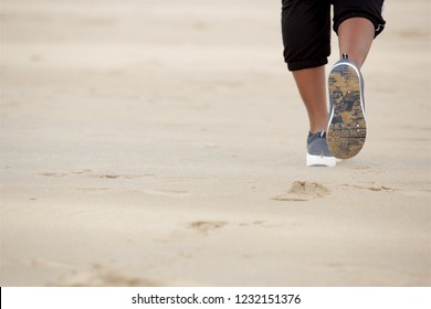 Close Up Horizontal Portrait Of African American Woman Walking On Sand At The Beach