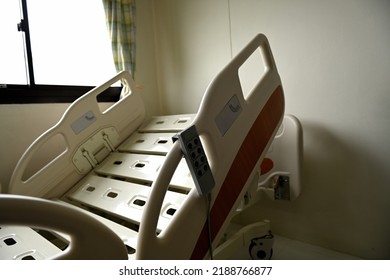 Close Up Of Hospital Bed With No Patient In Room.