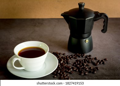 Close up hot of black coffee and Moka pot and coffee beans on dark table. Benefit of coffee concept.  - Powered by Shutterstock