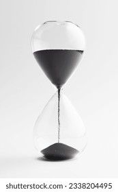 Close up of hourglass with black sand and copy space on white background. Time, timekeeping, shape and colour concept. - Shutterstock ID 2338204495