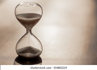 Close Up Of Hourglass Clock. Hourglass Time Passing Concept For Business Deadline, Urgency And Running Out Of Time