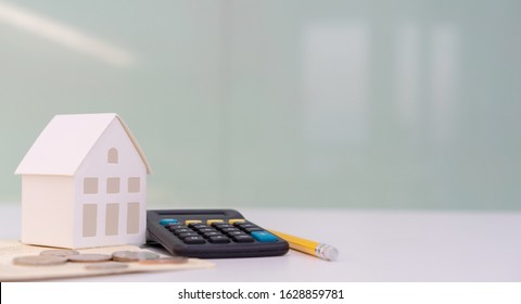 close up house's model on banking account book with calculator, coin and pencil on table for planning of home loan mortgage refinance or retention interest rates , business and financial concept - Shutterstock ID 1628859781