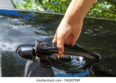 Close Up Of Human Child Hand Opening Car Door