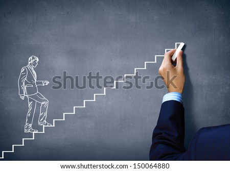 Close up of human hand drawing career ladder with chalk
