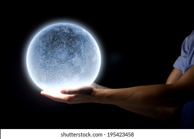 Close Up Of Human Hand Holding Blue Glowing Moon