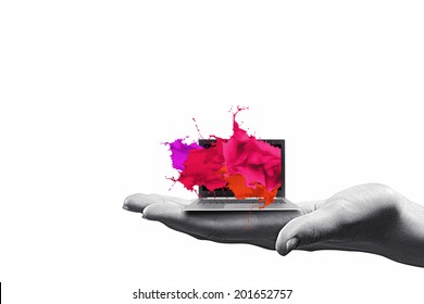 Close up of human hand holding laptop