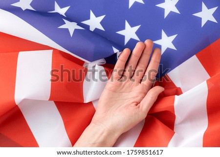 Close up of human hand on american flag.