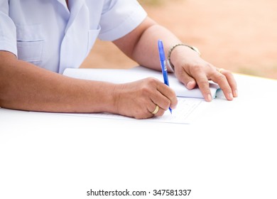 Close up Human Hand Signing on Formal Paper