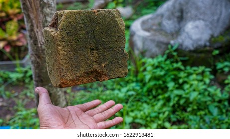 close up of human hands, and bricks that are floating