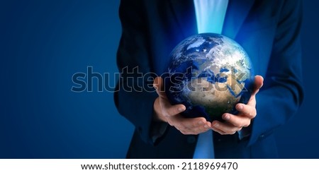 Close up human hands holding planet Earth. Earth day. Energy saving concept. World in business man hand on dark background. Save Earth. Environment Concept. Care of the Enviro.