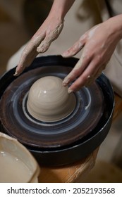 Close Up Of Human Hands Molding Clay On A Pottery Wheel