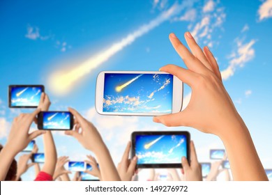 Close Up Of Human Hands Taking Photo Of Falling Meteorite