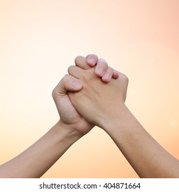 close up human handshake on blur warm gradient color background for confident or success or victory concept. - Shutterstock ID 404871664