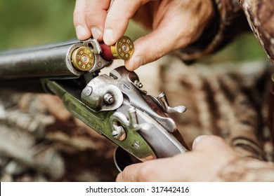 Close up of a hunter loading his weapon