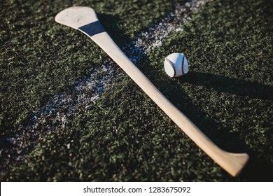 Close Up Of Hurl And Sliotar On Gaa Pitch 