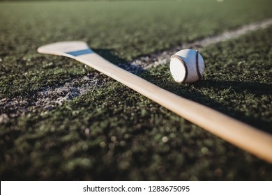 Close Up Of Hurl And Sliotar On Gaa Pitch 