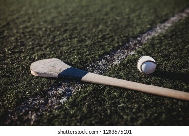 Close Up Of Hurl And Sliotar On Gaa Pitch 