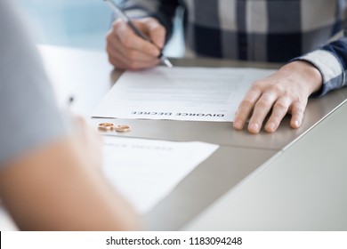 Close Up Of Husband Sign Divorce Decree Ending Relationships With Wife, Determined Man Put Signature On Document Finalizing Separation, Breaking Up Or Split Officially. Marriage Annulment Concept