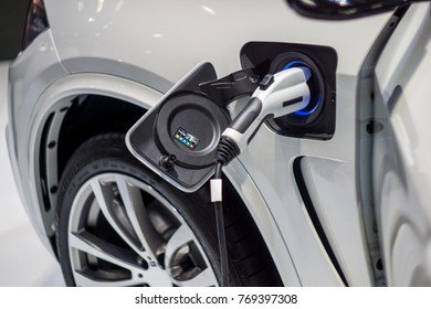  Close up of the Hybrid car electric charger station with power supply plugged into an electric car being charged. - Shutterstock ID 769397308