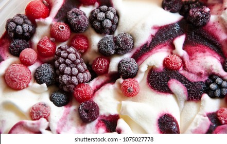 Close up of ice cream with forest frozen berries. Summer food dessert top.
