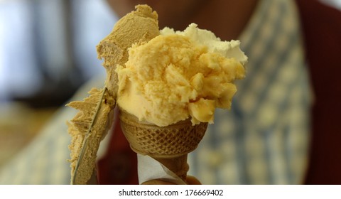 Close Up Of An Ice Cream Maker Preparing A Vanilla And Cream Waffle Cone.