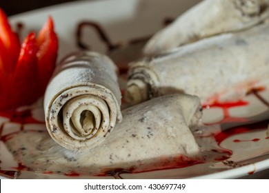close up of an ice cream roll served at a restaurant garnished with a red strawberry