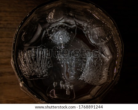 Close up of ice cubes floating on the cold water in glass.