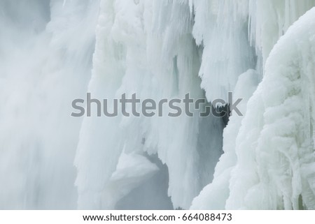 Close up of ice curtains and mist from waterfall in late Winter, Dorwin Falls, Rawdon, Quebec, Canada