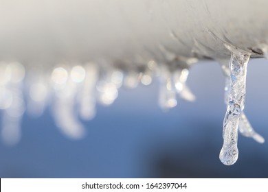 Close Up Of Icicles Coming Off Of A Displayed Wind Turbine Blade.