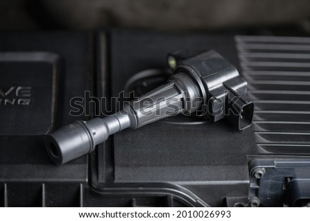 Close up ignition coil in the engine room, car maintenance concept. 