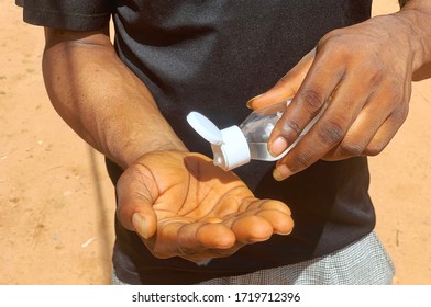 Close Up Image Of An African Boy Using Hand Sanitizer Yo Flight Against The Covid-19